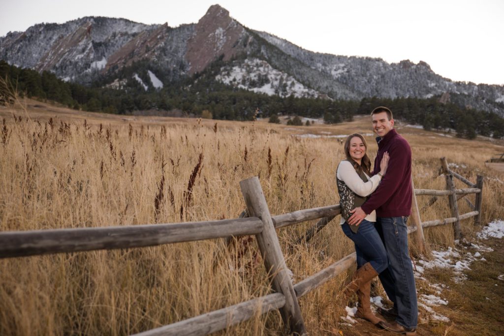Engaged couple in front of Flatirons