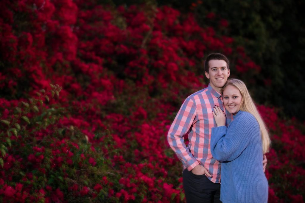 couple in front of flower wall in Santa Barbara