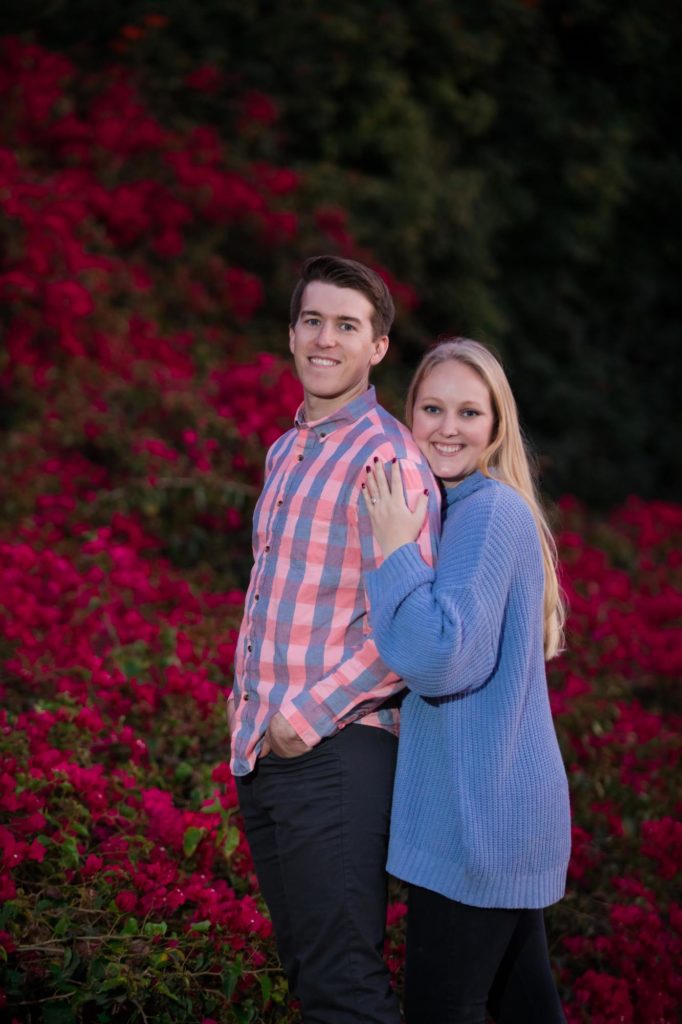 couple in front of flower wall in California