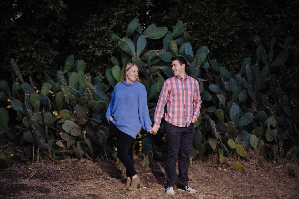 couple in front of giant cactus in California