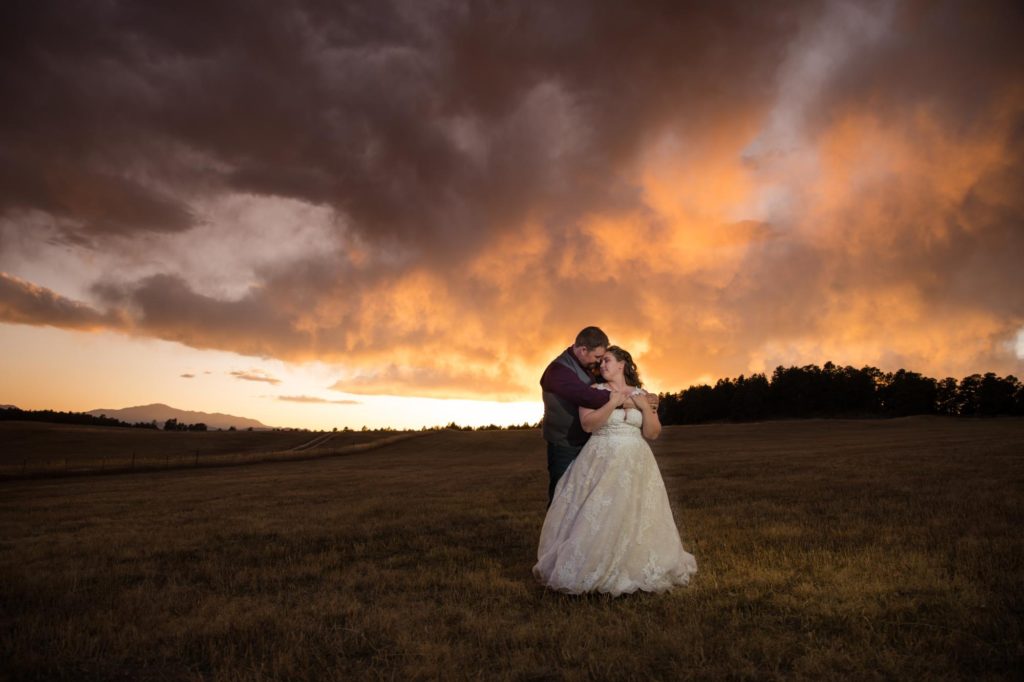 Colorado Springs couple in front of stormy sky