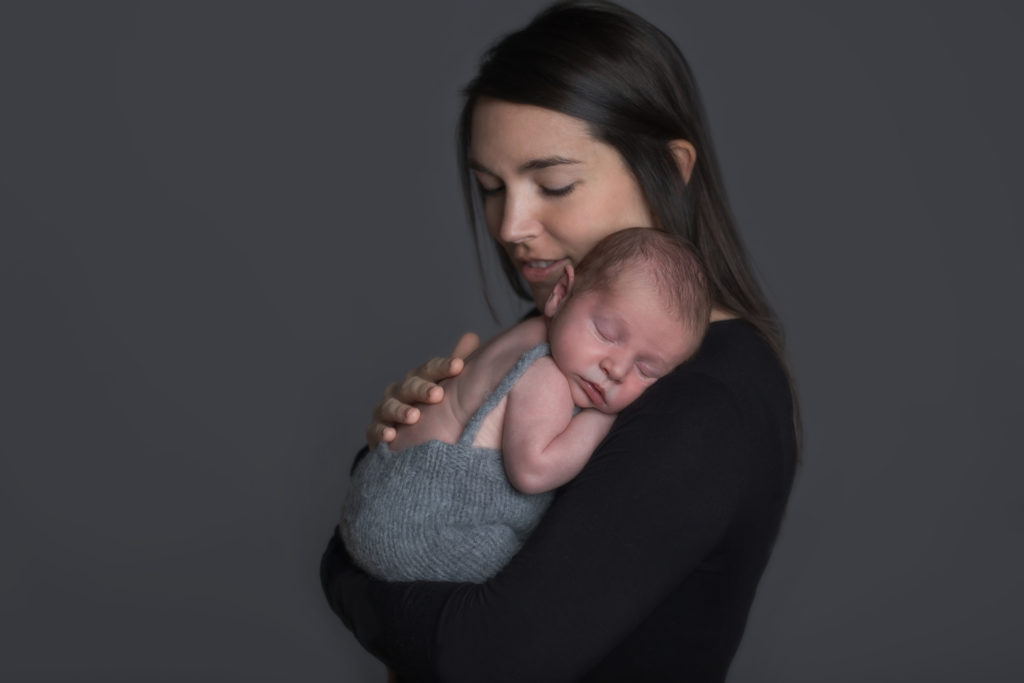 newborn asleep in mother's arms