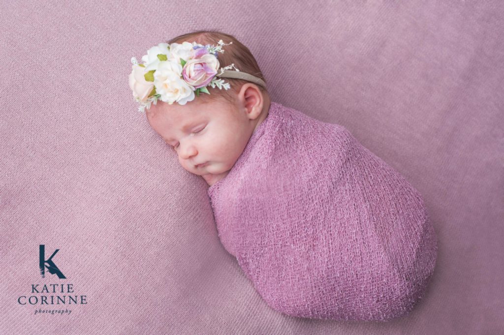 baby girl wrapped in pink swaddle