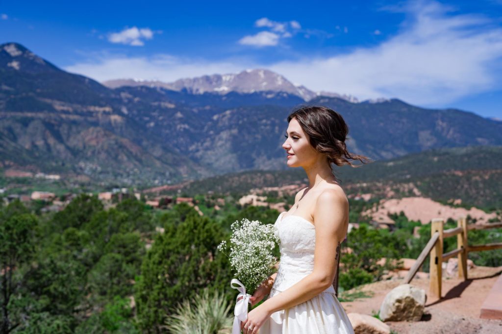 destination bride looks out over rocky mountains