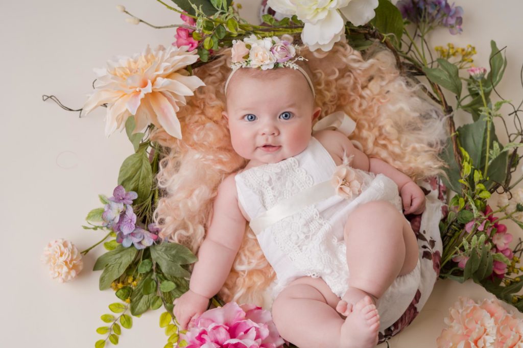 six month baby portraits with flowers