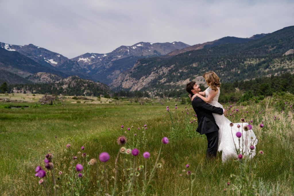 groom picks up bride at Rocky Mountain National Park