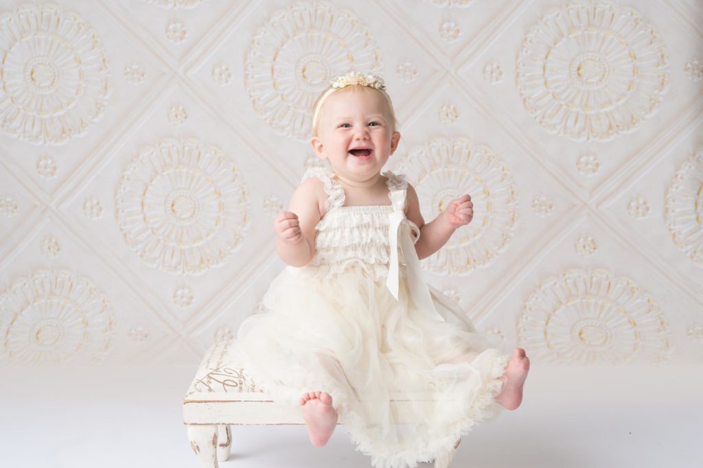 colorado baby girl laughs for photographer