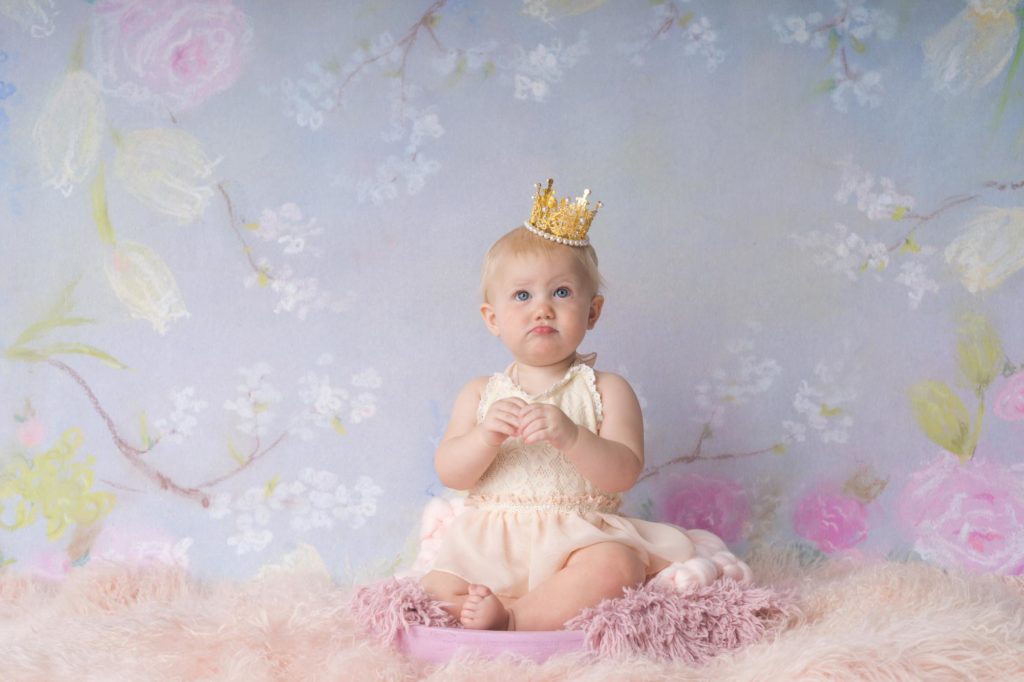 baby girl poses for birthday photos at Colorado studio