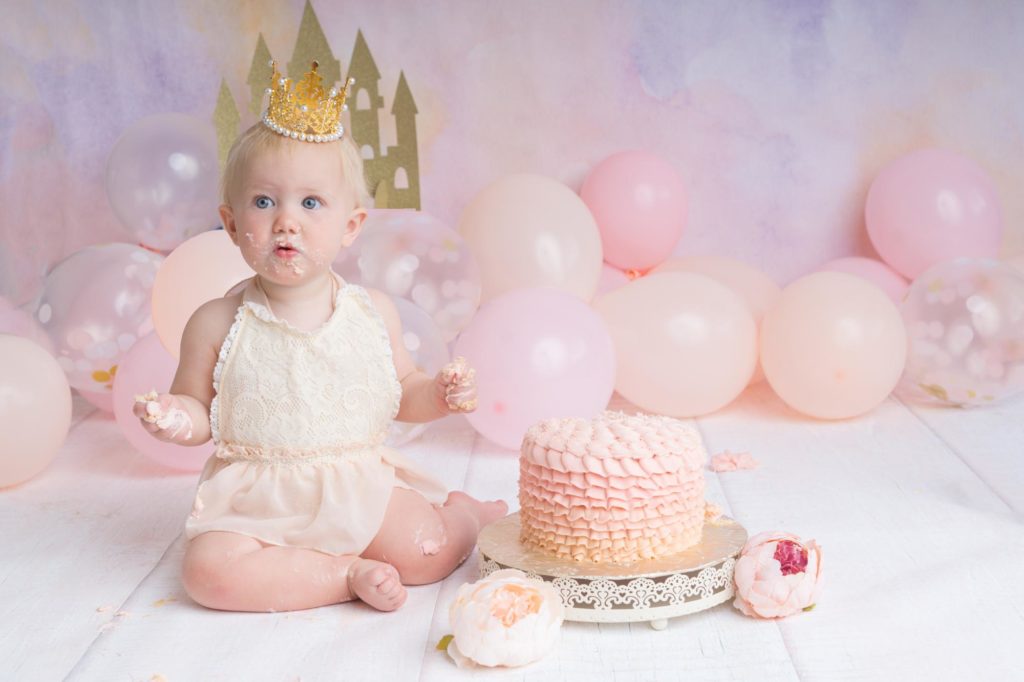 one year old girl at princess cake smash