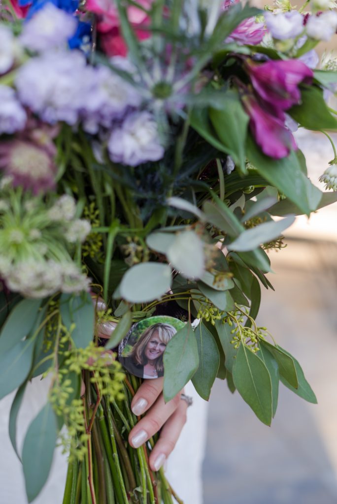 bride holds bouquet with loved ones portrait
