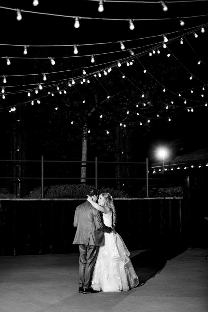 newlyweds dance on outdoor dancefloor