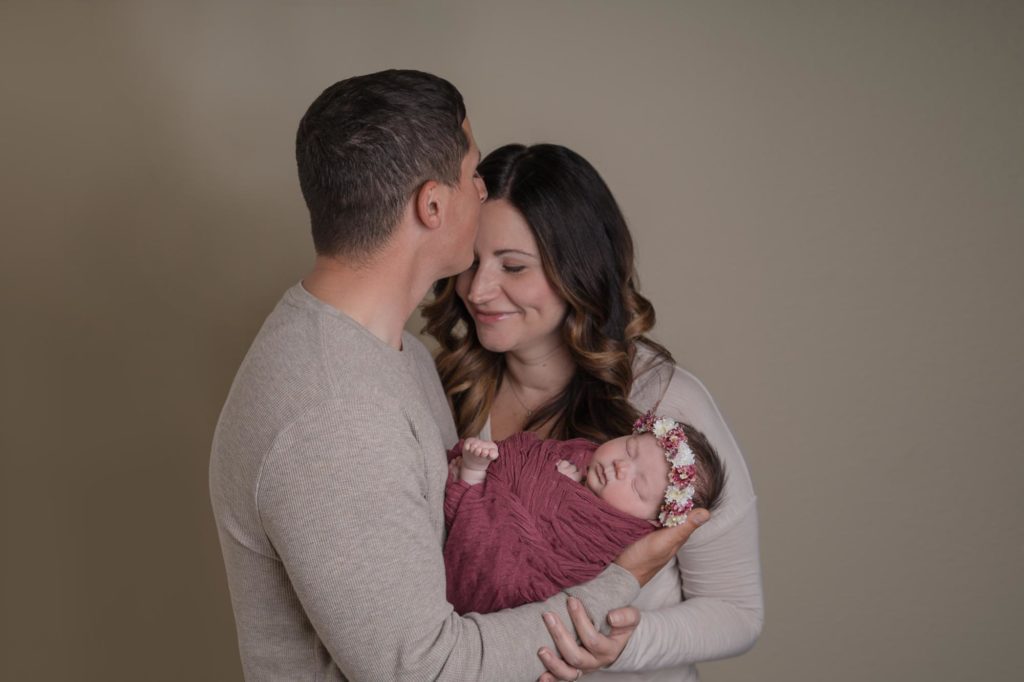 Military family holds newborn baby