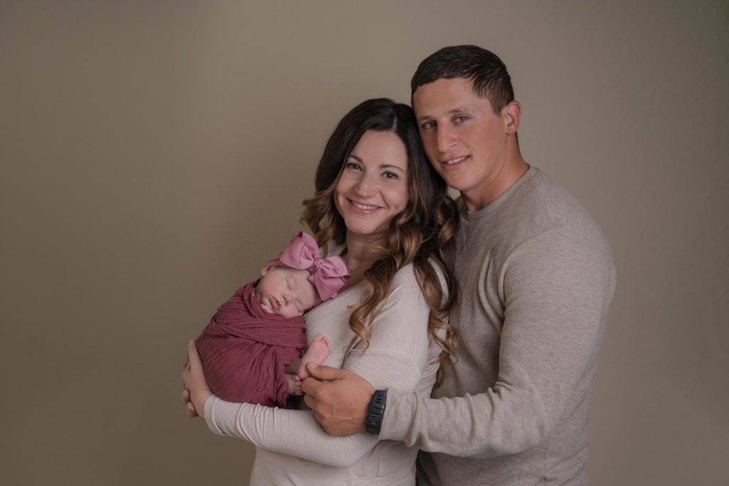 Military family holds newborn baby girl