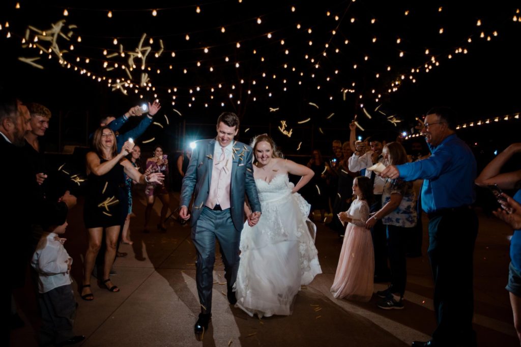 guests throw french fries at bride and groom
