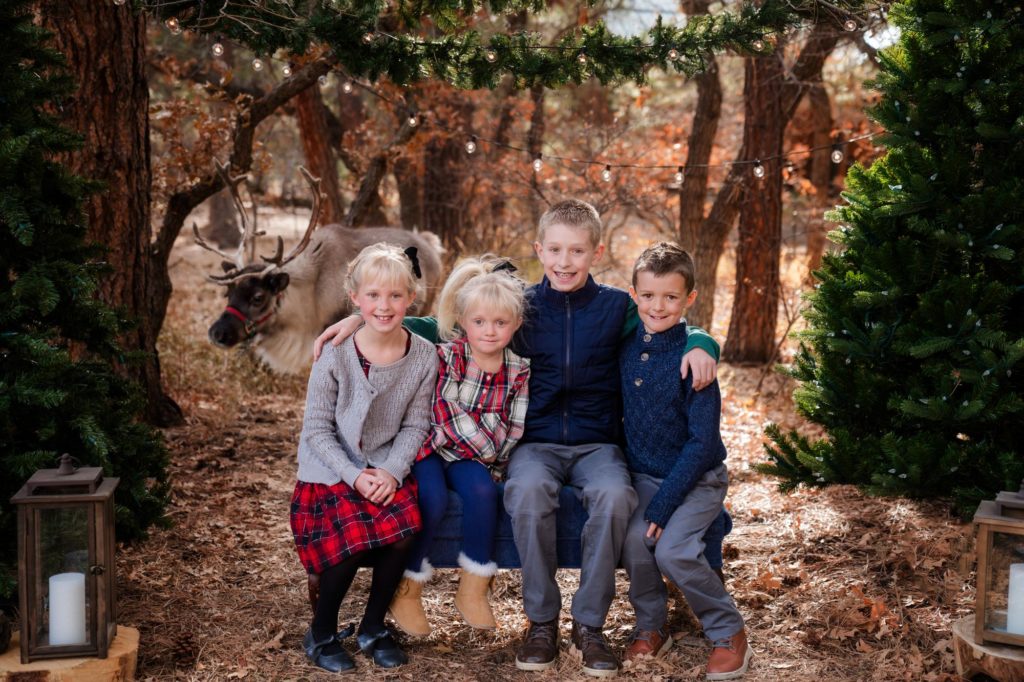 children pose for reideer christmas photo session