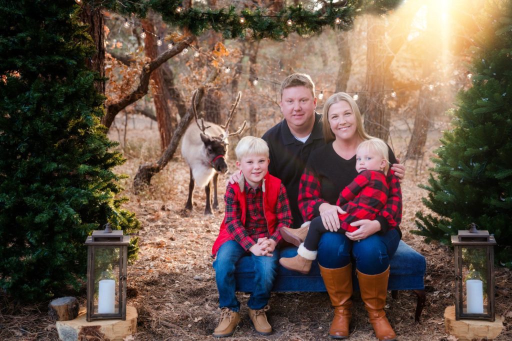 family poses for reideer christmas photo session