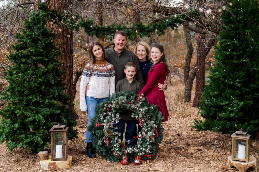 Family holds wreath for portrait