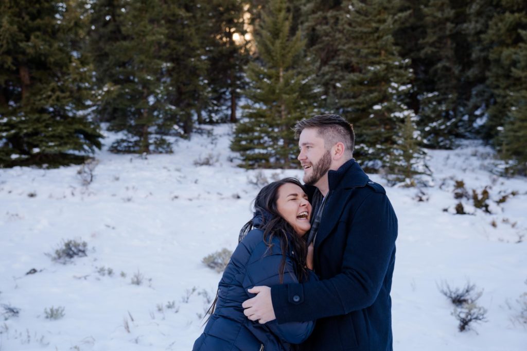 souple laughs while taking winter engagement photos