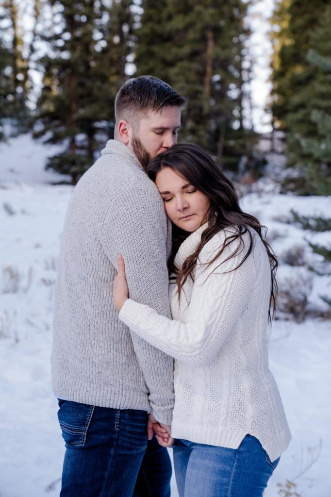 Colorado couple embraces during winter engagement photos