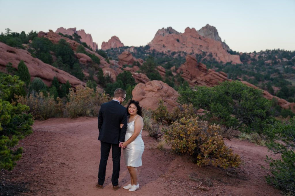 bride looks back at Colorado wedding photographer