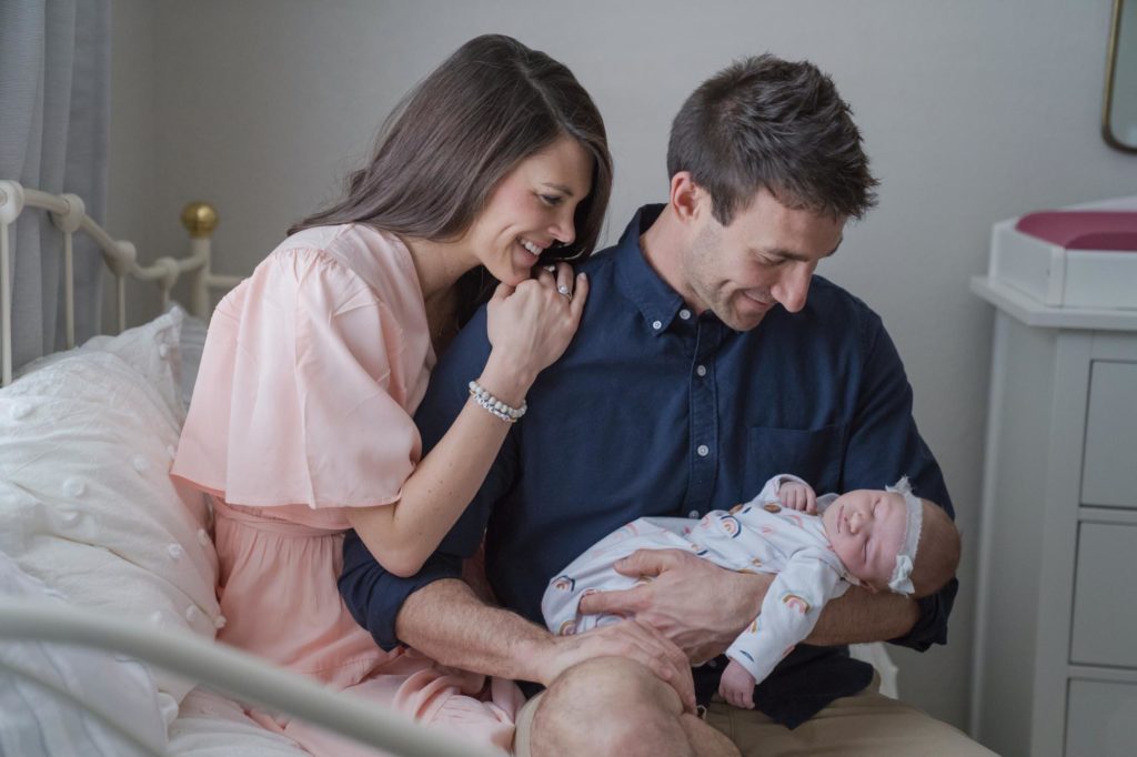 Monument couple holds newborn in their home