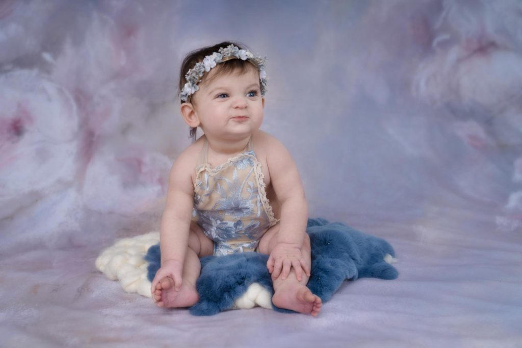 baby girl poses in photography studio
