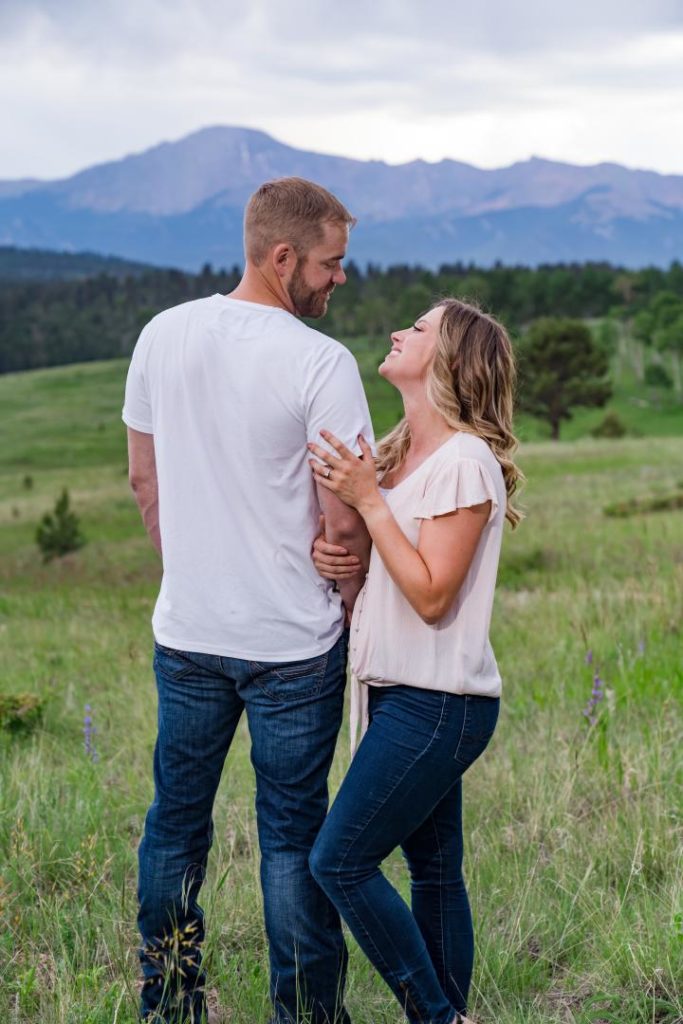 engaged couple poses for colorado photographer