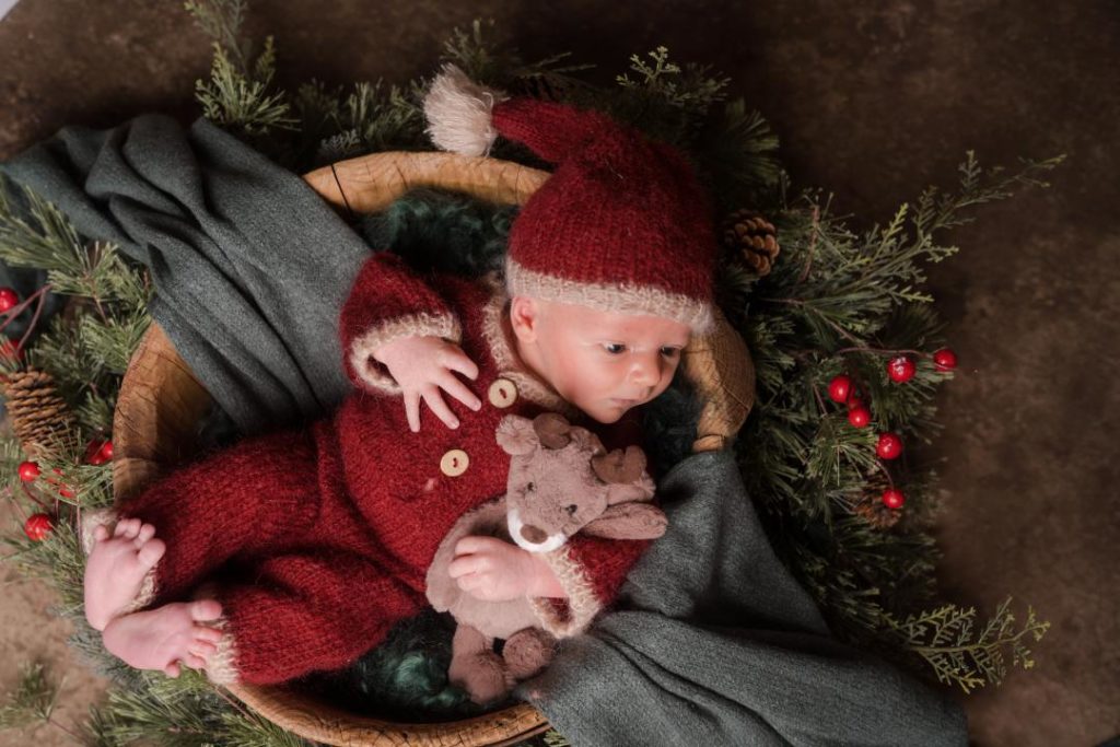 newborn baby boy in Santa outfit Christmas photos