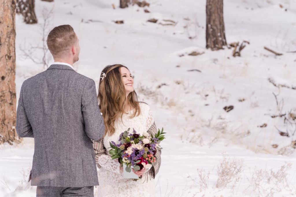 bride laughing at snowy elopement