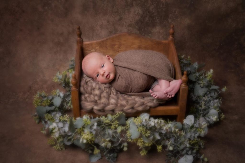 baby newborn photo in a mini crib