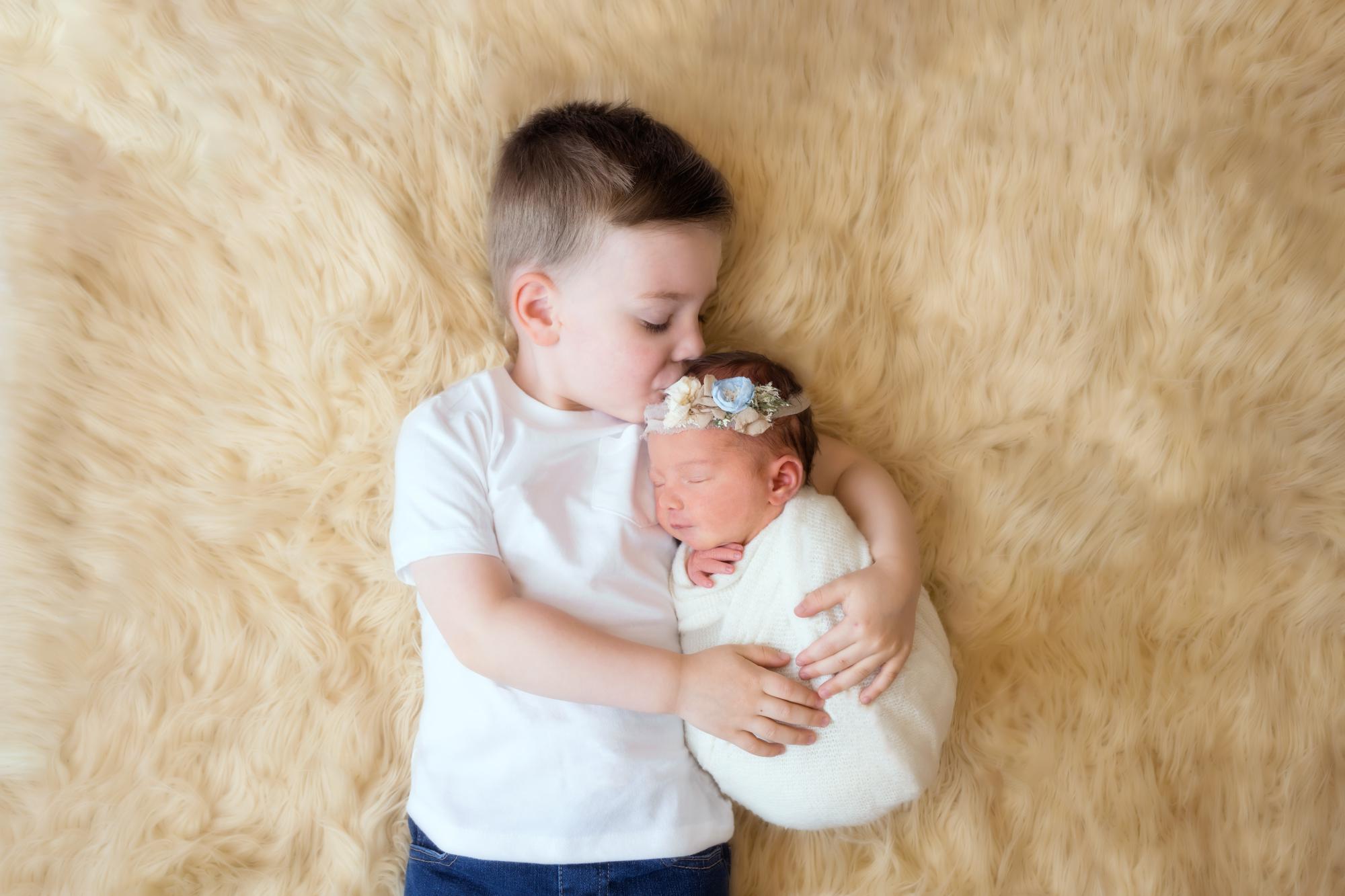 Newborn baby girl with brother siblings