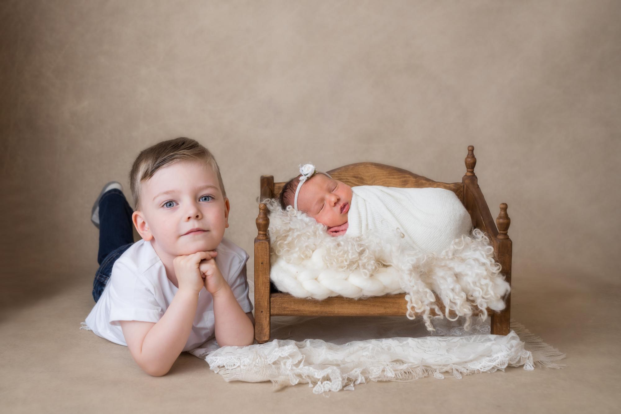 Newborn baby girl with brother sibling