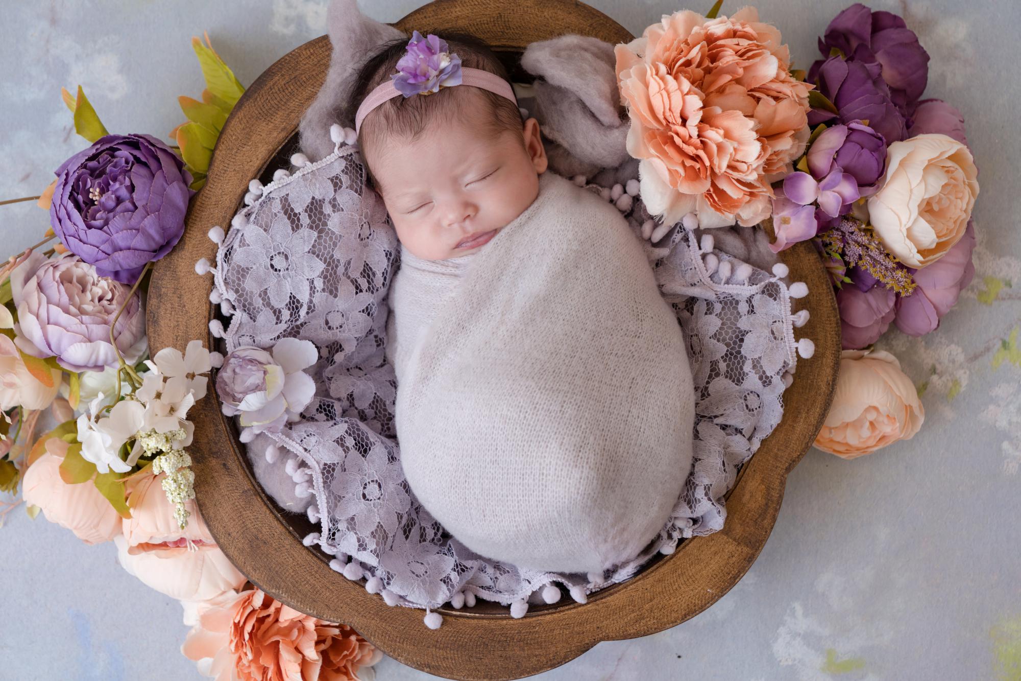 newborn baby in a basket